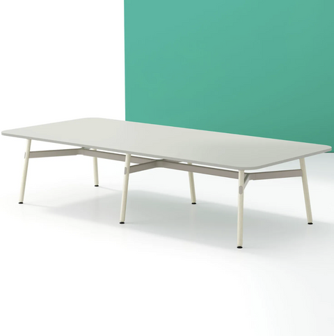 A long, rectangular Okidoki+ conference table with multiple leg options, featuring a light tabletop and light-colored frame
