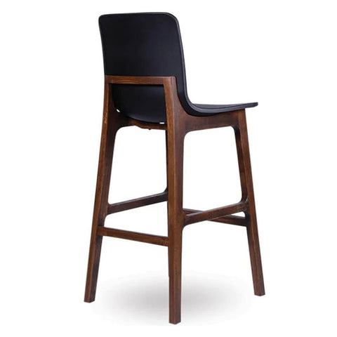 Black Ara stool with a contoured seat and timber walnut legs