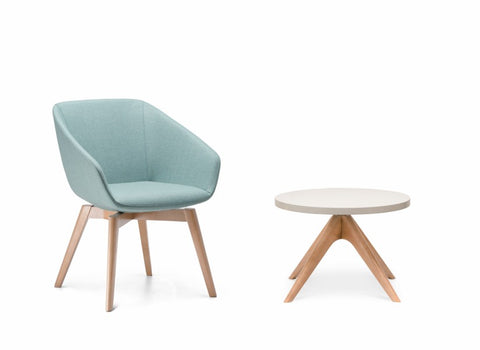 A round white coffee table with European ash timber legs paired with a chair