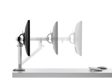 Flo single monitor arm mounted on a desk with a monitor, featuring adjustable length.