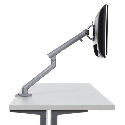 Side view of Flo single monitor arm mounted on a desk with a monitor, featuring adjustable clamp