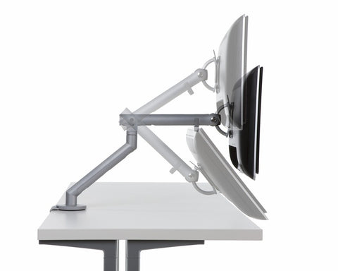 Side view of Flo single monitor arm mounted on a desk with a monitor, featuring adjustable angle