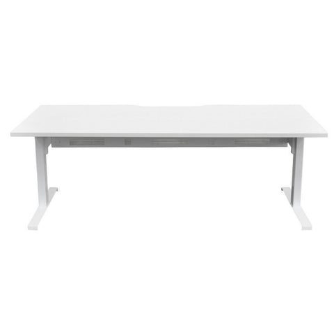 White height-adjustable desk with visible legs in low height position, sit-to-stand workstation for offices