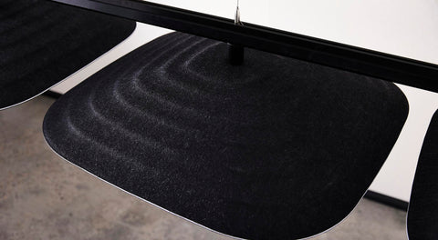 Top view of Fuji Ku large square black 3D acoustic tiles suspended from the ceiling