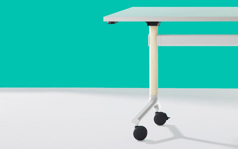Close up of Okidoki rectangle folding table with a white frame and cream wooden legs