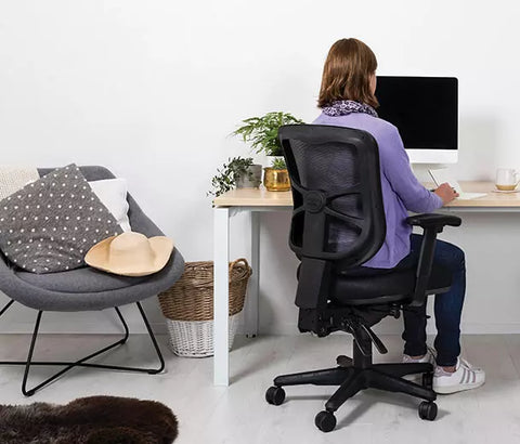 Buro ergonomic office chair with black mesh back and nylon seat in a home office setup, adjustable controls, five-star base with casters.
