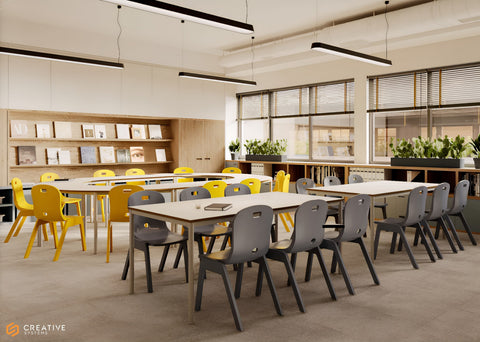A modern classroom or study space with long rectangular tables and chairs. The foreground tables are paired with gray chairs, while the tables on the left are paired with bright yellow chairs.