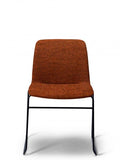 Breo terracotta upholstered chair with a black sled base