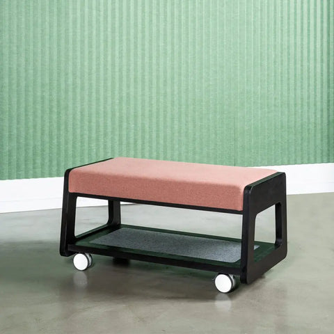Etch unit configured as a bench seat with black birch plywood base and pink upholstered seat cushion