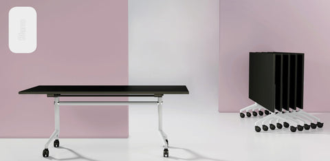 I.AM folding tables with black tops and white frames, shown side by side in upright and folded stackable positions
