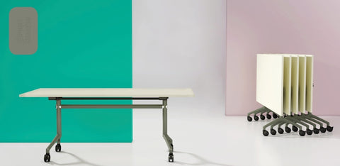 I.AM folding tables with white tops and green frames, shown side by side in upright and folded stackable positions
