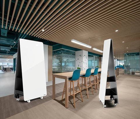 Jart mobile whiteboard with double-sided magnetic surface, concealed storage shelves and lockable castors, shown in a modern office setup