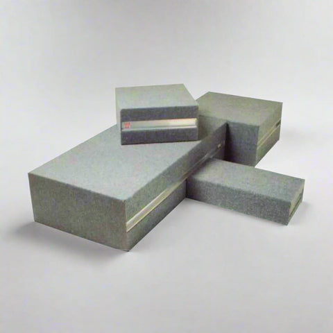 Stack of Keen Drama Blocks in light grey upholstery, showcasing custom fabric options and durable construction for school staging and classroom use