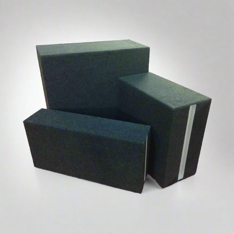 Three Keen Drama Blocks in green upholstery, displayed in various sizes on a white background, showcasing durable school staging blocks with heavy-duty construction and custom fabric finish.