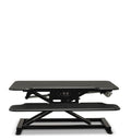 Vertilift Pro desk riser in black with keyboard platform extended to standing height