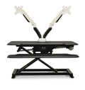 Vertilift Pro electric desk riser in black with dual monitor arms attached and keyboard platform