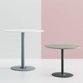 Two varying heights Disc Base Juno tables, one in white tabletop with scotland sky color frame and one in green tabletop with moonshine color frame