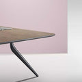 Close up of EONA rectangular modular table with a wooden tabletop and black metal legs.