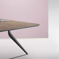 Close up of EONA rectangular modular table with a wooden tabletop and black metal legs.
