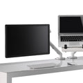 Flo dual monitor arm setup with one monitor and one laptop, desk-clamp mounted with adjustable joints for angle and length