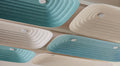 Close up of Fuji Juni acoustic ceiling tile with a long rectangular shape in two colors