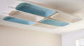 Fuji Juni long rectangular acoustic tile in two colours with art deco curve and embossed linework, fixed to a ceiling.