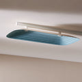 Fuji Juni dual colour long rectangular acoustic tile with art deco curve and embossed linework, fixed to a ceiling.
