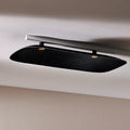 Fuji Juni black long rectangular acoustic tile with art deco curve and embossed linework, fixed to a ceiling.