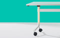 Close up of Okidoki rectangle folding table with a white frame and cream wooden legs