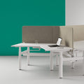 Modern office workstation with LOVOC screen frame mounted to a desk for privacy and workspace separation