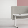 A modern office workstation featuring a light gray LOVOC frame mounted upholstered screen