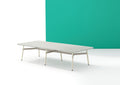 A long, rectangular Okidoki+ conference table with multiple leg options, featuring a light tabletop and light-colored frame