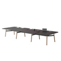 A long, rectangular Okidoki+ conference table with multiple leg options, featuring a dark tabletop and light-colored frame