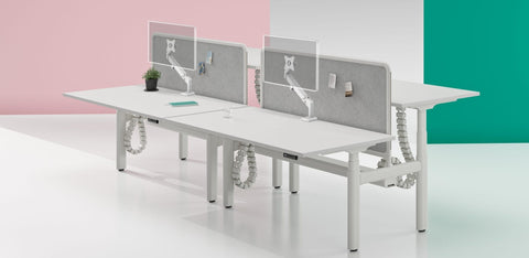 Vader Single Monitor Arm with empty VESA plate for monitor attachment, mounted on desk in an office setup