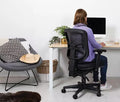 Buro ergonomic office chair with black mesh back and nylon seat in a home office setup, adjustable controls, five-star base with casters.