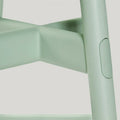 Close up of Okidoki stool in green finish timber legs 